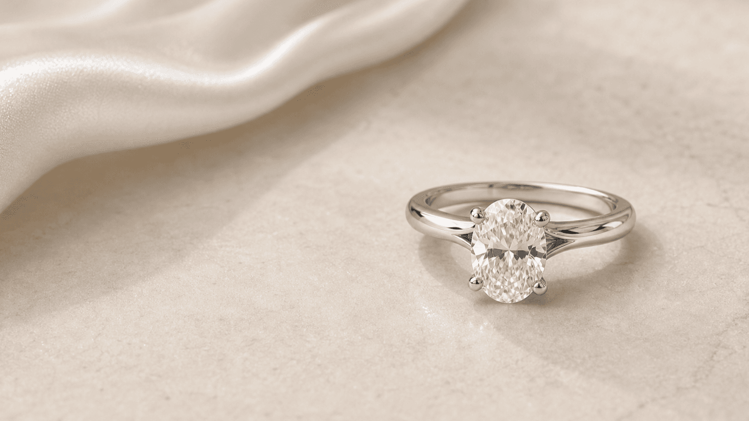 Estelle Oval Diamond Engagement Ring styled on a neutral surface for a lab-grown diamond education guide